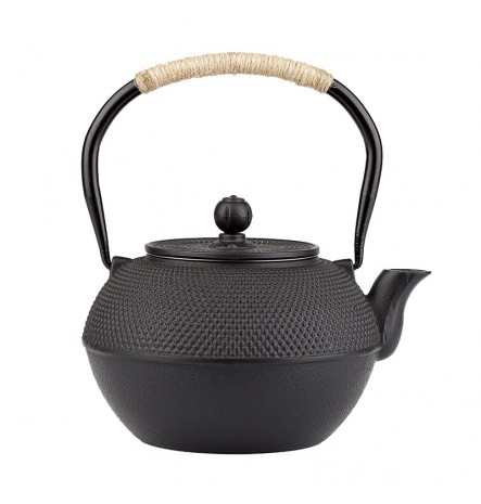 A cast iron teapot boils water to make tea